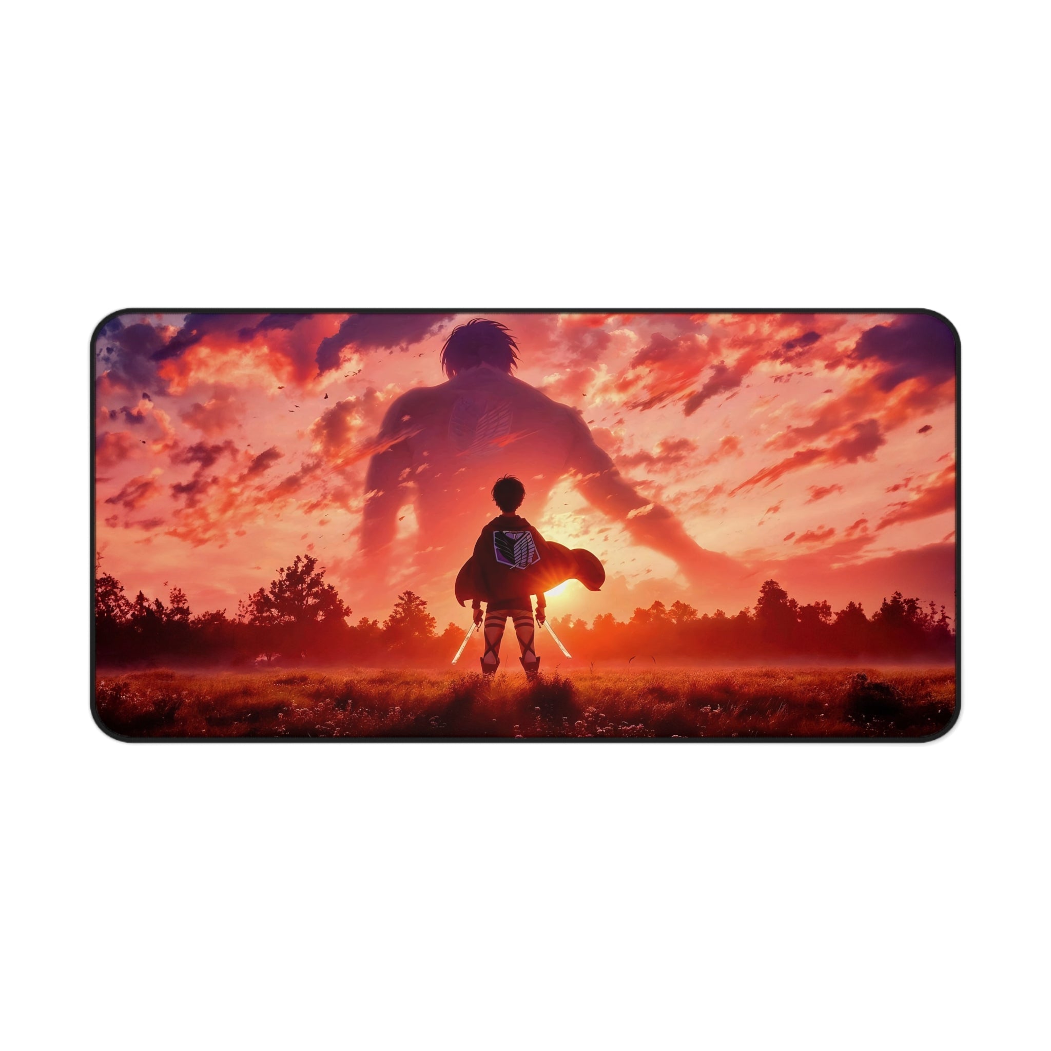 A rectangular desk mat with rounded corners featuring an Attack on Titan anime-style illustration of Eren Yeager standing in a field with ODM swords, facing a giant silhouette of the Attack Titan against a dramatic orange and pink sunset sky.