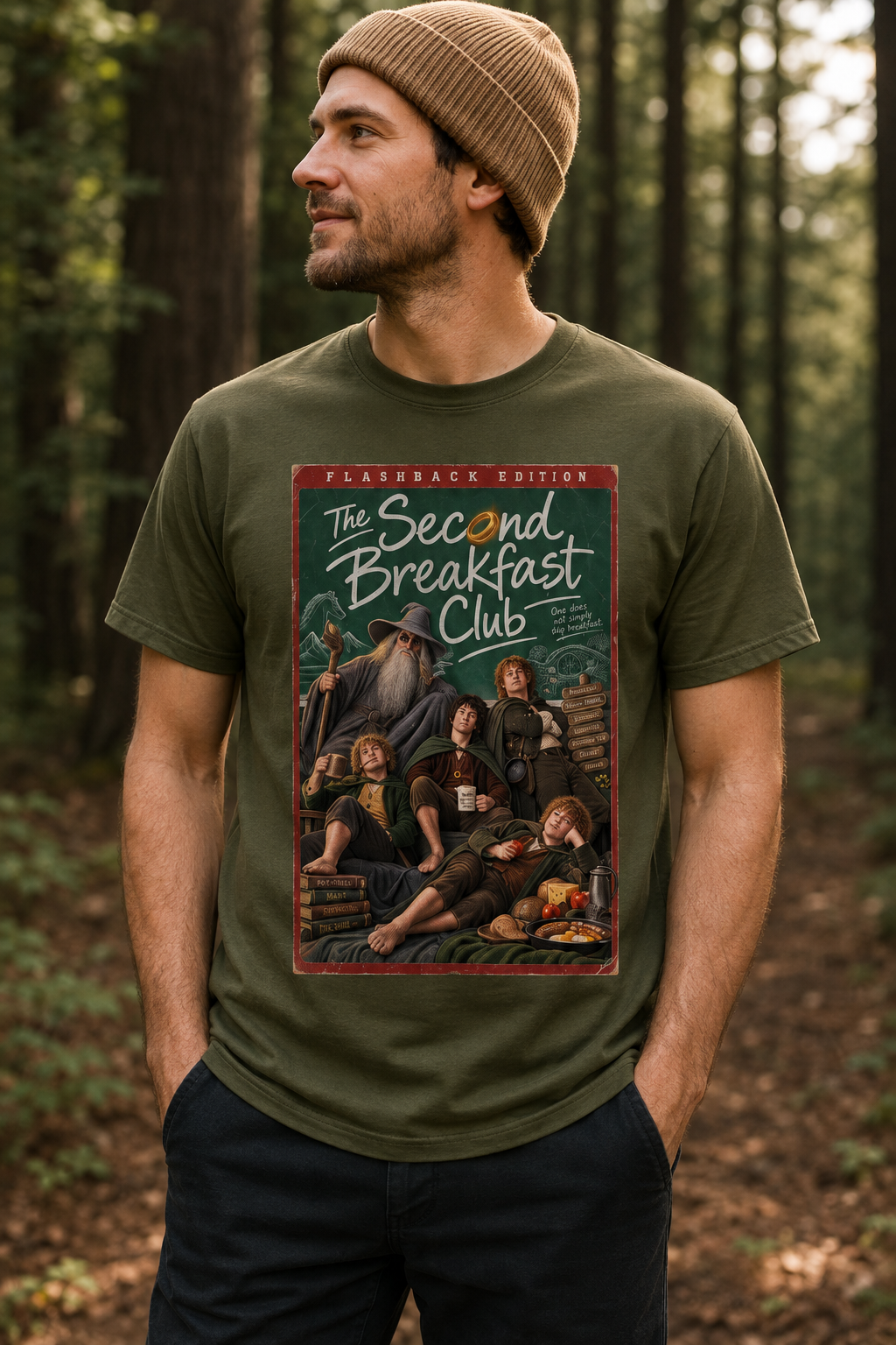 A man wearing an army green short-sleeve lord of the rings t-shirt with a large graphic print on the front featuring character parody of 'The Second Breakfast Club' in a vintage comic-book / dvd video style. The graphic includes the text 'FLASHBACK EDITION' and 'The Second Breakfast Club'.